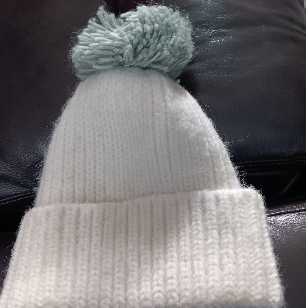 White winter hat with green &white pom pom